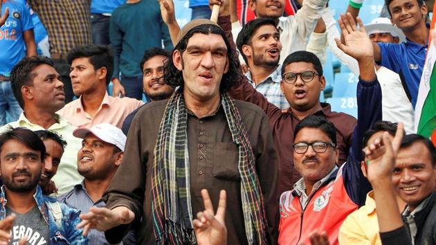 Lucknow: 8-feet tall Afghan cricket fan Sher Khan watches the one-day international cricket series between Afghanistan and West Indies, in Lucknow, Wednesday, Nov. 6, 2019. Khan visited many hotels in search of a place to stay but no hotel allegedly agreed to rent him a room due to his height. (PTI) Lucknow: 8-feet tall Afghan cricket fan Sher Khan watches the one-day international cricket series between Afghanistan and West Indies, in Lucknow, Wednesday, Nov. 6, 2019. Khan visited many hotels in search of a place to stay but no hotel allegedly agreed to rent him a room due to his height. (PTI)