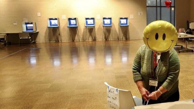 Election judge Carol Johnson ties a balloon to a chair before the polls, at the Arlington Hills Community Center in St. Paul, Minnesota, US. (David Joles / AP)