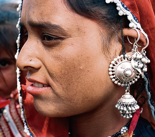 A woman from the Lohar community shows off a newly crafted silver earing. (LightRocket via Getty Images) A woman from the Lohar community shows off a newly crafted silver earing. (LightRocket via Getty Images)