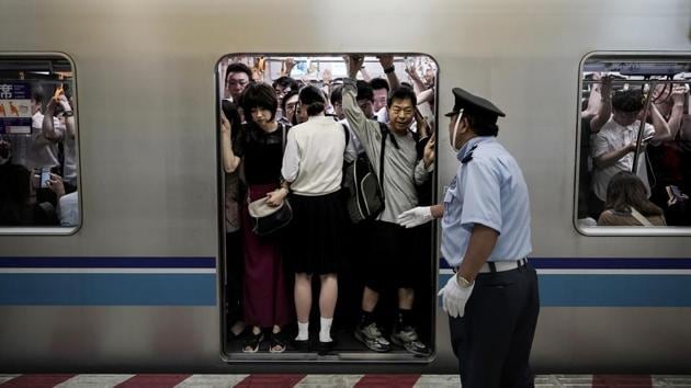 Taguchi’s study predicts 15 stations will experience greater than 200% capacity, with several reaching nearly 400% at their peak. Since Tokyo last hosted the Summer Olympics in 1964, railways have designated special oshiya, or “pushers,” to pack commuters into rush hour cars— often wearing white gloves. Locals are accustomed to the treatment, but visitors may not be. (Jae C. Hong / AP) Taguchi’s study predicts 15 stations will experience greater than 200% capacity, with several reaching nearly 400% at their peak. Since Tokyo last hosted the Summer Olympics in 1964, railways have designated special oshiya, or “pushers,” to pack commuters into rush hour cars— often wearing white gloves. Locals are accustomed to the treatment, but visitors may not be. (Jae C. Hong / AP)