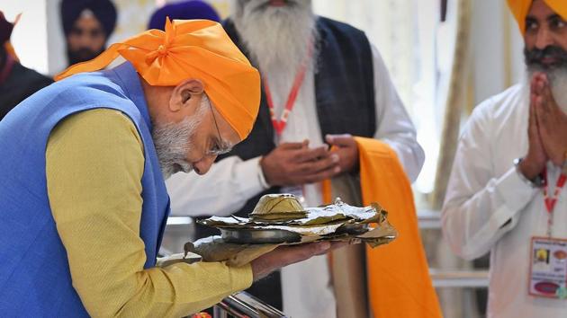 Prime Minister Narendra Modi receives 'parsad' after paying obeisance at Gurdwara Sri Ber Sahib in Sultanpur Lodhi, Punjab on Saturday. (PTI) Prime Minister Narendra Modi receives 'parsad' after paying obeisance at Gurdwara Sri Ber Sahib in Sultanpur Lodhi, Punjab on Saturday. (PTI)