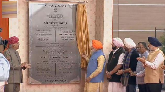 Prime Minister Narendra Modi unveils a plaque during the inauguration of the integrated check-post of Kartarpur Corridor at Dera Baba Nanak in Gurdaspur. Modi wore an orange headscarf and offered prayers at Punjab’s Ber Sahib Gurdwara at Sultanpur Lodhi on Saturday morning before heading to Dera Baba Nanak in Gurdaspur for the historic opening of the Kartarpur corridor that will link two shrines. (PTI) 