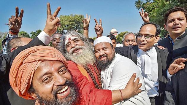 People celebrate the Ayodhya case verdict, outside the Supreme Court in New Delhi on Saturday.(PTI Photo)