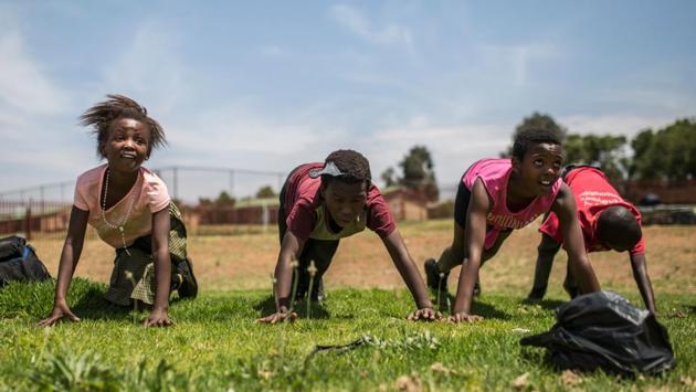 Female players from the Soweto Rugby Schools Academy perform pushups as part of their physical training at the Moletsane Sports Complex in Soweto. Khanyisile Makumbana knew she couldn’t miss the Springboks’ victorious parade through Soweto after their Rugby World Cup triumph in Japan. The 16-year-old plays rugby and was overcome with emotion as she watched a hugely symbolic trip through a neighbourhood where the rugby team was once reviled. (Guillem Sartorio / AFP) Female players from the Soweto Rugby Schools Academy perform pushups as part of their physical training at the Moletsane Sports Complex in Soweto. Khanyisile Makumbana knew she couldn’t miss the Springboks’ victorious parade through Soweto after their Rugby World Cup triumph in Japan. The 16-year-old plays rugby and was overcome with emotion as she watched a hugely symbolic trip through a neighbourhood where the rugby team was once reviled. (Guillem Sartorio / AFP)