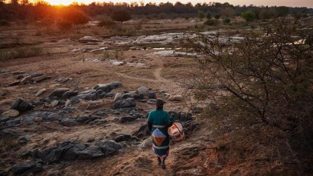 Phephu Mchavi, 62, walks in to the riverbank of the Klein Letaba River near Baleni. The harvesting is done only by women, who often camp in the dry river bed for weeks to make the most of the dry season before the spring rains fall. “The sulphate water from the hot spring flows... the heat from the sun dries it, then we have this sort of salt there,” local guide Thinashaka Tshivhase said. (Michele Spatari / AFP) Phephu Mchavi, 62, walks in to the riverbank of the Klein Letaba River near Baleni. The harvesting is done only by women, who often camp in the dry river bed for weeks to make the most of the dry season before the spring rains fall. “The sulphate water from the hot spring flows... the heat from the sun dries it, then we have this sort of salt there,” local guide Thinashaka Tshivhase said. (Michele Spatari / AFP)
