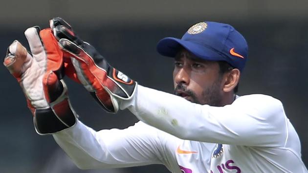 India's Wriddhiman Saha prepares to catch the ball during a training session.(AP)