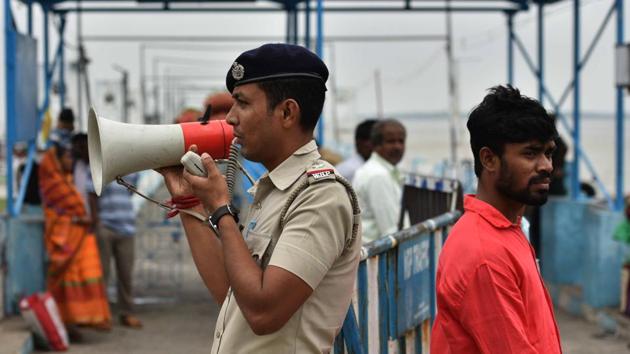 A police personnel makes an announcement on a loudspeaker for Cyclone Bulbul, at Harwood point jetty, South 24 Parganas. The India Meteorological Department said that Bulbul took around four hours to cover the Sunderbans spread across North 24 Parganas districts. In all, eight people have lost their lives in the state. “Initial reports say 3,500 houses have been damaged,” said North 24 Parganas district magistrate Chaitali Chakraborti. (Samir Jana / HT Photo) A police personnel makes an announcement on a loudspeaker for Cyclone Bulbul, at Harwood point jetty, South 24 Parganas. The India Meteorological Department said that Bulbul took around four hours to cover the Sunderbans spread across North 24 Parganas districts. In all, eight people have lost their lives in the state. “Initial reports say 3,500 houses have been damaged,” said North 24 Parganas district magistrate Chaitali Chakraborti. (Samir Jana / HT Photo)