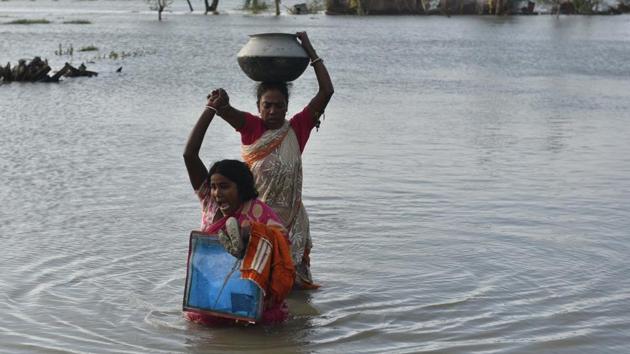 Women carry their belongings from a house submerged in water, at Amarabati village. Union home minister Amit Shah said that the Centre was supporting the cyclone-hit states. He tweeted that 10 teams of National Disaster Relief Force (NDRF) were in West Bengal and six in Odisha to assist the state governments in carrying out relief measures. He added that additional 18 NDRF teams were on standby. (Samir Jana / HT Photo) Women carry their belongings from a house submerged in water, at Amarabati village. Union home minister Amit Shah said that the Centre was supporting the cyclone-hit states. He tweeted that 10 teams of National Disaster Relief Force (NDRF) were in West Bengal and six in Odisha to assist the state governments in carrying out relief measures. He added that additional 18 NDRF teams were on standby. (Samir Jana / HT Photo)