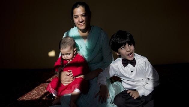 A Kashmiri-born Australian Sumaya Rather is seen with her eight-month-old daughter Noor Rather and four-year-old son Ahmed Rather inside her maternal home on the outskirts of Srinagar. Sumaya said Noor fell ill because she couldn’t adjust to the milk supplement brands that were available in Srinagar. Taking her to a hospital was a big challenge as there were protests and road blockades set up by both soldiers and Kashmiri youths. (Dar Yasin / AP) A Kashmiri-born Australian Sumaya Rather is seen with her eight-month-old daughter Noor Rather and four-year-old son Ahmed Rather inside her maternal home on the outskirts of Srinagar. Sumaya said Noor fell ill because she couldn’t adjust to the milk supplement brands that were available in Srinagar. Taking her to a hospital was a big challenge as there were protests and road blockades set up by both soldiers and Kashmiri youths. (Dar Yasin / AP)