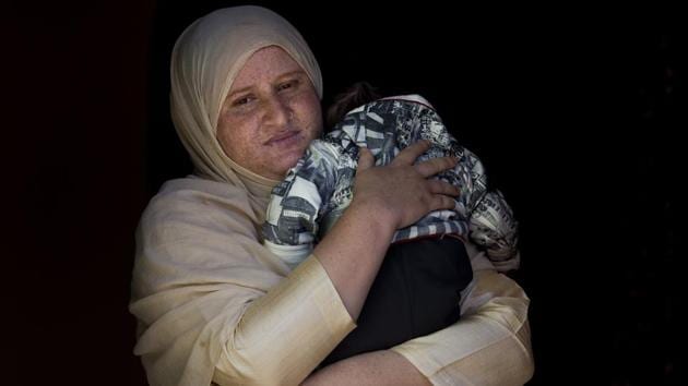 Zahida Jahangir holds her two-month-old son Mohammad Taimor inside their home in Lolab. Taimor was born premature and put on a ventilator in a children’s hospital while Zahida was receiving treatment in another hospital. Because of the lockdown there was no way to tell Zahida when her son was ready for breast milk so the hospital settled for milk supplement. Zahida was reunited with Taimor 20 days after he was first put on a ventilator. (Dar Yasin / AP) Zahida Jahangir holds her two-month-old son Mohammad Taimor inside their home in Lolab. Taimor was born premature and put on a ventilator in a children’s hospital while Zahida was receiving treatment in another hospital. Because of the lockdown there was no way to tell Zahida when her son was ready for breast milk so the hospital settled for milk supplement. Zahida was reunited with Taimor 20 days after he was first put on a ventilator. (Dar Yasin / AP)