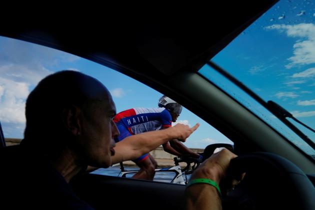 Odvelt Clerge, 19, a member of the Haiti national cycling team is followed by his coach Yann Dejan in his car as he competes during the individual time trial at the Caribbean Cycling Championship. The UCI will continue to support Haitian cycling for the time being and they are hoping for the distribution bicycles in schools and youth clubs, once the political situation has calmed down. (Alexandre Meneghini / REUTERS)