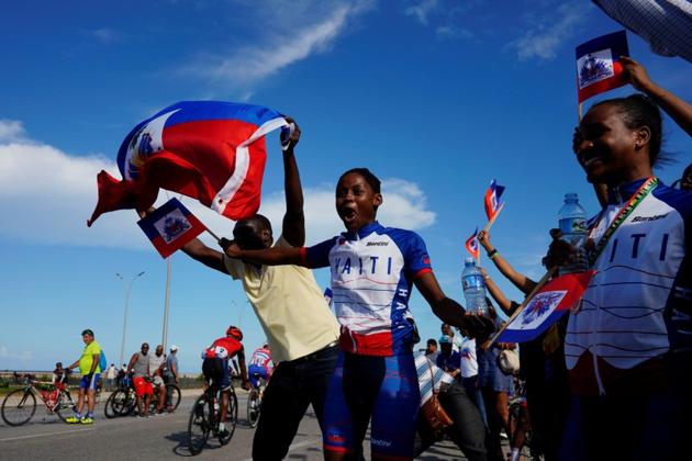 Members of the Haiti national cycling team react to teammates approaching the finish line at the Caribbean Cycling Championship. Dejan, who has trained cyclists from all over the world, said cycling tournaments, had proven very popular in poor nations because they offered a free outdoor spectacle. Haiti was applying to host the Caribbean Championships in 2021, he said. “Cycling could be a way of giving the Haitian people back their smiles,” he said. (Alexandre Meneghini / REUTERS)
