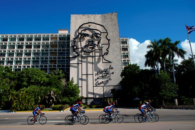 Members of the Haiti national cycling team ride past a building with an image of late revolutionary Ernesto "Che" Guevara during a training session. The protests, over corruption and inequality, prevented Haiti from hosting the championship of more than 20 nations this year as originally planned, which would have provided the country an economic and morale boost. (Alexandre Meneghini / REUTERS)