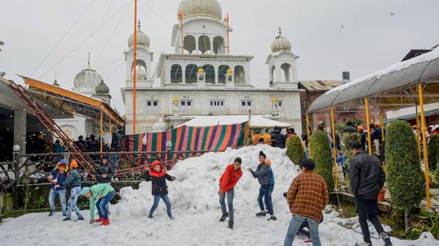 Children play with snow at Chatti Padshahi Gurudwara during the celebration of 550th birth anniversary of Guru Nanak Dev, at Ranawari in Srinagar. (PTI) Children play with snow at Chatti Padshahi Gurudwara during the celebration of 550th birth anniversary of Guru Nanak Dev, at Ranawari in Srinagar. (PTI)