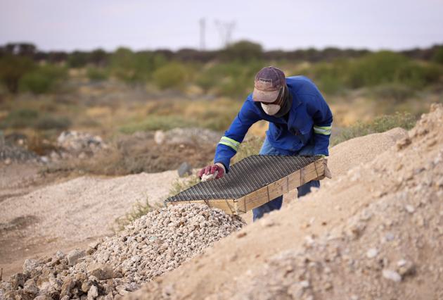 A member of the Batho Pele cooperative of artisanal miners sifts through sand and rocks searching for diamonds.The aim of the government-backed scheme was to curb illegal mining and black-market trade of diamonds, and serve as a blueprint for future attempts elsewhere in the country, not only in the diamond sector, but also potentially manganese, gold and chrome.However the project has been hit by violence and with informal miners. (Sumaya Hisham / REUTERS) A member of the Batho Pele cooperative of artisanal miners sifts through sand and rocks searching for diamonds.The aim of the government-backed scheme was to curb illegal mining and black-market trade of diamonds, and serve as a blueprint for future attempts elsewhere in the country, not only in the diamond sector, but also potentially manganese, gold and chrome.However the project has been hit by violence and with informal miners. (Sumaya Hisham / REUTERS)