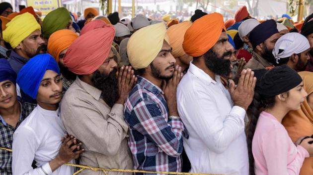 Sikh devotees gesture as they pay their respects on the occasion of the 550th birth anniversary of Guru Nanak Dev at Gurudwara Ber Sahib at Sultanpur Lodhi, in Punjab. (NARINDER NANU / AFP) Sikh devotees gesture as they pay their respects on the occasion of the 550th birth anniversary of Guru Nanak Dev at Gurudwara Ber Sahib at Sultanpur Lodhi, in Punjab. (NARINDER NANU / AFP)