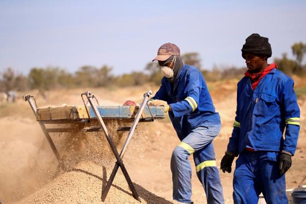 Miners sift through sand and rocks as they search for diamonds. The diamonds in the area of Kimberley mined by the cooperative are expected to run out in about five years. “Our dream is that, when we give the land back to Ekapa, 90% of us will have something in our pockets,” said 44-year-old miner Kagiso Nofomela, who hails from the town of Kuruman. “We must have money, cars, homes and our kids must be educated.” (Sumaya Hisham / REUTERS) Miners sift through sand and rocks as they search for diamonds. The diamonds in the area of Kimberley mined by the cooperative are expected to run out in about five years. “Our dream is that, when we give the land back to Ekapa, 90% of us will have something in our pockets,” said 44-year-old miner Kagiso Nofomela, who hails from the town of Kuruman. “We must have money, cars, homes and our kids must be educated.” (Sumaya Hisham / REUTERS)