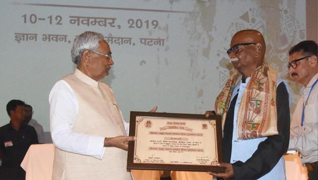 Bihar Chief Minister Nitish Kumar is honouring Prem Verma during Shiksha Diwas function at Gyan Bhawan in Patna. Bihar India on Monday(Sanotsh Kumar/ HT photos)