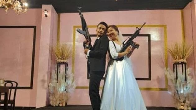 A young couple who posed with automatic assault rifles at their wedding reception in Nagaland’s commercial hub Dimapur last week was arrested on Wednesday. They were later released on bail. (HT Photo) A young couple who posed with automatic assault rifles at their wedding reception in Nagaland’s commercial hub Dimapur last week was arrested on Wednesday. They were later released on bail. (HT Photo)