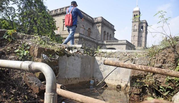 Dirty water collected at an open space on SPPU campus. Potholes, small ponds and open gutters spread dengue as they are a breeding ground for mosquitoes. (Pratham Gokhale/HT Photo) Dirty water collected at an open space on SPPU campus. Potholes, small ponds and open gutters spread dengue as they are a breeding ground for mosquitoes. (Pratham Gokhale/HT Photo)
