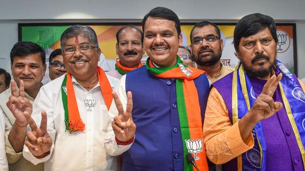 Maharashtra Chief Minister Devendra Fadnavis, State BJP president Chandrakant Patil and RPI chief Ramdas Athawale flash victory signs as they celebrate their win in Maharashtra Assembly elections on October 24, in Mumbai. However, Fadnavis could not stake claim after bitter tussle with its alliance partner led by Uddhav Thackeray demanded a written assurance that a Sena nominee would be given the chance to be chief minister after 30 months. (Shashank Parade / PTI) Maharashtra Chief Minister Devendra Fadnavis, State BJP president Chandrakant Patil and RPI chief Ramdas Athawale flash victory signs as they celebrate their win in Maharashtra Assembly elections on October 24, in Mumbai. However, Fadnavis could not stake claim after bitter tussle with its alliance partner led by Uddhav Thackeray demanded a written assurance that a Sena nominee would be given the chance to be chief minister after 30 months. (Shashank Parade / PTI)