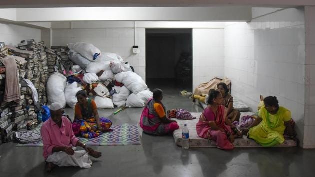 Affected residents of Tangewala colony take shelter at Kamgar Kalyan hall after the flash floods. (HT PHOTO) Affected residents of Tangewala colony take shelter at Kamgar Kalyan hall after the flash floods. (HT PHOTO)