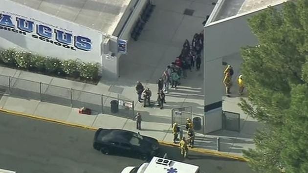 People are lead out of Saugus High School after reports of a shooting on Thursday, Nov. 14, 2019 in Santa Clarita, Calif. The Los Angeles County Sheriff’s Department says on Twitter that deputies are responding to the high school about 30 miles (48 kilometers) northwest of downtown Los Angeles. The sheriff’s office says a male suspect in black clothing was seen at the school.(AP) People are lead out of Saugus High School after reports of a shooting on Thursday, Nov. 14, 2019 in Santa Clarita, Calif. The Los Angeles County Sheriff’s Department says on Twitter that deputies are responding to the high school about 30 miles (48 kilometers) northwest of downtown Los Angeles. The sheriff’s office says a male suspect in black clothing was seen at the school.(AP)