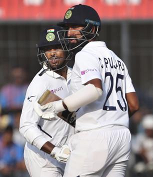 India's Cheteshwar Pujara, right, and Mayank Agarwal run between the wickets. (AP)