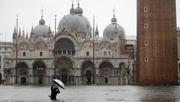 A photographer takes pictures in a flooded St. Mark's Square, in Venice, Italy, Tuesday, November 12, 2019. Much of Venice was under water on Wednesday night after the highest tide in 50 years ripped through the historic Italian city, beaching gondolas, trashing hotels and sending tourists fleeing through rapidly rising waters. (Luca Bruno / AP) A photographer takes pictures in a flooded St. Mark's Square, in Venice, Italy, Tuesday, November 12, 2019. Much of Venice was under water on Wednesday night after the highest tide in 50 years ripped through the historic Italian city, beaching gondolas, trashing hotels and sending tourists fleeing through rapidly rising waters. (Luca Bruno / AP)