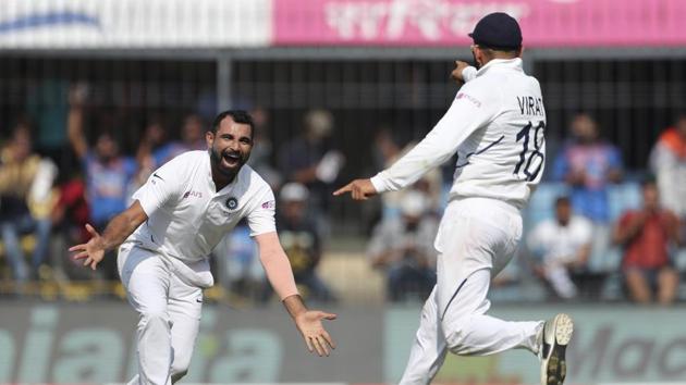 India's Mohammed Shami, left, celebrates with captain Virat Kohli the dismissal of Bangladesh's Mushfiqur Rahim during the first day of first cricket test match between India and Bangladesh in Indore, India, Thursday, Nov. 14, 2019. (AP Photo/Aijaz Rahi)(AP)