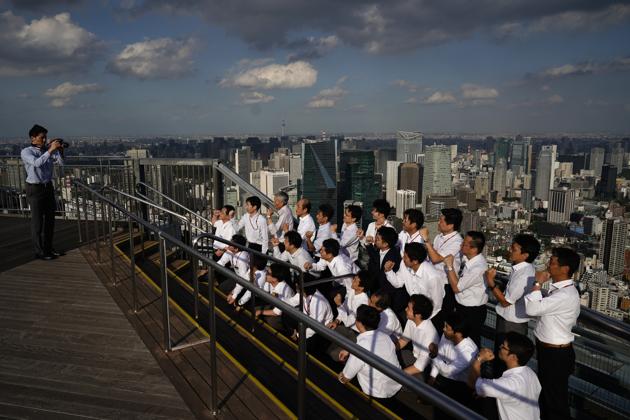 A group of Japanese pose for a photo on an open-air observation deck located on the rooftop of Roppongi Hills Mori Tower. (Jae C. Hong / AP) A group of Japanese pose for a photo on an open-air observation deck located on the rooftop of Roppongi Hills Mori Tower. (Jae C. Hong / AP)