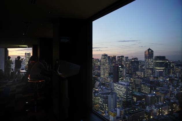 People take pictures of Tokyo's skyline during sunset from the Seaside Top observatory located on the 40th floor of the World Trade Center building. (Jae C. Hong / AP) People take pictures of Tokyo's skyline during sunset from the Seaside Top observatory located on the 40th floor of the World Trade Center building. (Jae C. Hong / AP)