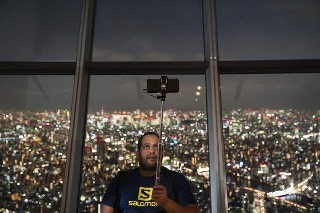 Chandre Groenewald, visiting from South Africa, clicks a selfie at Tokyo Skytree's observation deck. Greeted with a bow by the elevator operator, ride up to the top of some structures for as much as $30 a trip. But the Tokyo Metropolitan Government building’s observation deck is free. The 48-story office is surrounded by Shinjuku district’s skyscrapers. The view is more intimate than from most other observatories. (Jae C. Hong / AP) Chandre Groenewald, visiting from South Africa, clicks a selfie at Tokyo Skytree's observation deck. Greeted with a bow by the elevator operator, ride up to the top of some structures for as much as $30 a trip. But the Tokyo Metropolitan Government building’s observation deck is free. The 48-story office is surrounded by Shinjuku district’s skyscrapers. The view is more intimate than from most other observatories. (Jae C. Hong / AP)