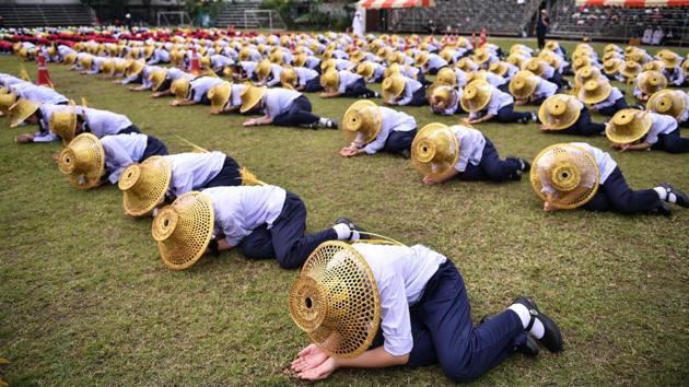 Thai students hold a rehearsal at a school ground in Bangkok on November 13, 2019 in preparation for Pope Francis' visit. (CHALINEE THIRASUPA / AFP)