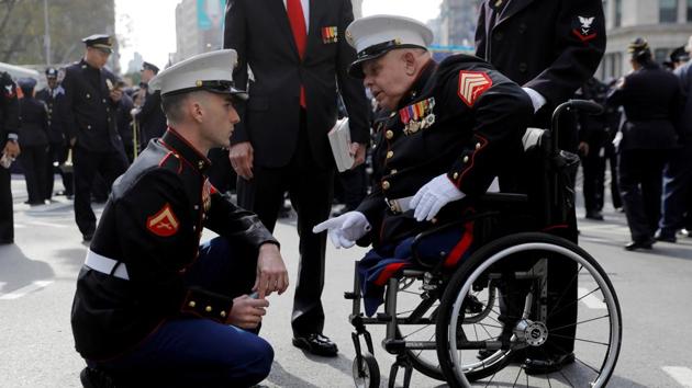 Lance Corporal James Duggan, 23, of the United States Marine Corp speaks with Sargent Michael Sulsona, 67, a United States Marine Corp Vietnam War veteran and recipient of a Purple Heart and Bronze Star, before the Veterans Day Parade in Manhattan, New York City, U.S. (Andrew Kelly / REUTERS)