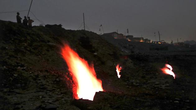 Flames billow out of the fissures on the ground above coal mines in the village of Liloripathra in Jharia, a remote corner of eastern Jharkhand state, India. The fires started in 1916. More than a century later, they are still spewing flames and clouds of poisonous fumes into the air, forcing residents to brave sizzling temperatures, deadly sinkholes and toxic gases. (Aijaz Rahi / AP) Flames billow out of the fissures on the ground above coal mines in the village of Liloripathra in Jharia, a remote corner of eastern Jharkhand state, India. The fires started in 1916. More than a century later, they are still spewing flames and clouds of poisonous fumes into the air, forcing residents to brave sizzling temperatures, deadly sinkholes and toxic gases. (Aijaz Rahi / AP)