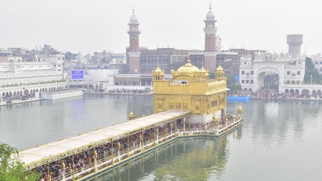Devotees gather to pay obeisance at Golden Temple on the occasion of the 550th birth anniversary of Guru Nanak Dev Ji, in Amritsar, Punjab, on November 12. (Sameer Sehgal / HT Photo) Devotees gather to pay obeisance at Golden Temple on the occasion of the 550th birth anniversary of Guru Nanak Dev Ji, in Amritsar, Punjab, on November 12. (Sameer Sehgal / HT Photo)