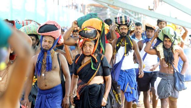 A woman is seen among the crowd of devotees at the Pamba base camp of Sabarimala Temple, in Pathanamthitta, Kerala. The Supreme Court on Thursday referred pleas seeking a review of its September 2018 order allowing the entry of women of all ages into Sabarimala Temple to a larger seven - judge without staying it, saying gender-based restrictions were not limited to the Kerala shrine but were also prevalent in places of worship of other religions. (Vivek R Nair/ HT Photo) A woman is seen among the crowd of devotees at the Pamba base camp of Sabarimala Temple, in Pathanamthitta, Kerala. The Supreme Court on Thursday referred pleas seeking a review of its September 2018 order allowing the entry of women of all ages into Sabarimala Temple to a larger seven - judge without staying it, saying gender-based restrictions were not limited to the Kerala shrine but were also prevalent in places of worship of other religions. (Vivek R Nair/ HT Photo)