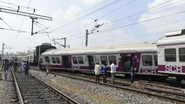 Railway workers and onlookers stand next to the askew carriages of a suburban rail train after it collided with an intercity express train at Kachiguda Railway Station in Hyderabad, Andhra Pradesh. Twelve people were injured in the accident. (Noah Seelam / AFP) Railway workers and onlookers stand next to the askew carriages of a suburban rail train after it collided with an intercity express train at Kachiguda Railway Station in Hyderabad, Andhra Pradesh. Twelve people were injured in the accident. (Noah Seelam / AFP)