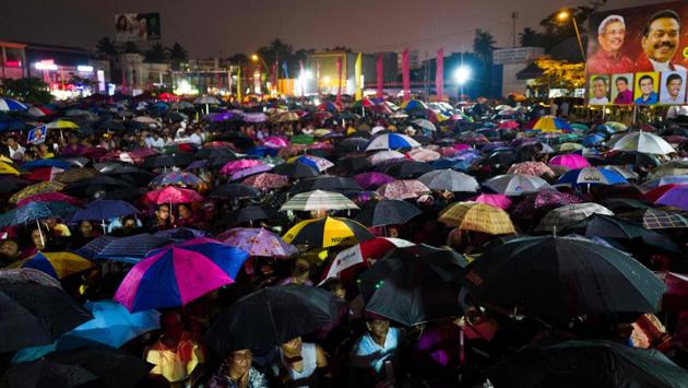Supporters of Sri Lanka Podujana Peramuna (SLPP) party presidential candidate Gotabhaya Rajapaksa attend a campaign rally under the rain in Homagama, ahead of the November 16 presidential election. Police stepped up security across Sri Lanka on November 13 over fears of violence on the final day of campaigning for the fiercely contested presidential election, officials said. (Jewel SAMAD / AFP)