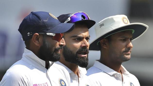 India's captain Virat Kohli, center, talks to teammates Mohammed Shami, left, and Mayank Agarwal.(AP)