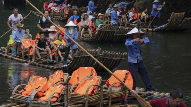 Tourists ride in bamboo rafts during a tour of the Nine Bends River in Wuyishan. But a key question looms over the project: Can China marry the goals of conservation and tourism, while safeguarding the livelihoods and culture of the approximately 128,000 people who live within or near the park’s boundaries, many of them Tibetan? (Ng Han Guan / AP)