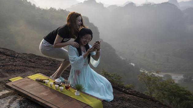 Women work on a photo for their tea products. The ambition to create a unified park system represents “a new and serious effort to safeguard China’s biodiversity and natural heritage,” Duke University ecologist Stuart Pimm says. The area also is home to some iconic and threatened species as the snow leopard and Chinese mountain cat, and encompasses the headwaters of three of Asia’s great waterway -- the Yangtze, Yellow and Mekong rivers. (Ng Han Guan / AP)