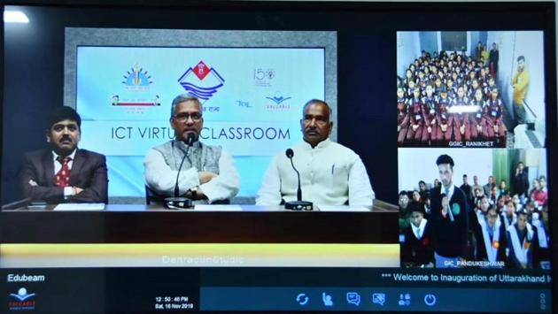 Chief minister Trivendra Singh Rawat (C) and education minister Arvind Pandey (R) interact with students of government schools using the virtual classroom technology from a studio set up in Dehradun on Saturday. (HT Photo) Chief minister Trivendra Singh Rawat (C) and education minister Arvind Pandey (R) interact with students of government schools using the virtual classroom technology from a studio set up in Dehradun on Saturday. (HT Photo)