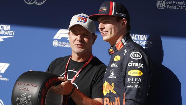 Red Bull driver Max Verstappen, of the Netherlands, right, and former driver Rubens Barrichello of Brazil pose for photos.(AP)