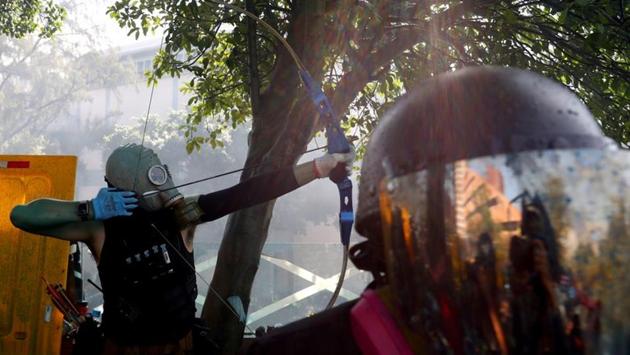An anti-government protester uses a bow during clashes with police. The protests which began over a proposed extradition law by the Hong Kong administration sparked fear of extradition of locals to the Chinese mainland for prosecution. It later turned into a major pro-democracy movement with demands to elect their local officials without the Chinese interference. (thit Perawongmetha / REUTERS) 