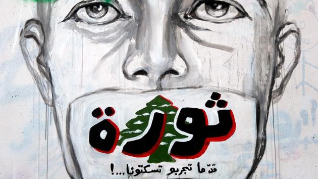 A graffiti reading "Revolution...even if you try to silence us" is sprayed on a wall in central Beirut. Lebanon’s uprising -- like protests elsewhere in the Middle East and Latin America -- is both political and social. “It’s also about personal liberation, which is the foundation of a revolution,” Mawad said. He sees symbolism in graffiti. (JOSEPH EID / AFP)
