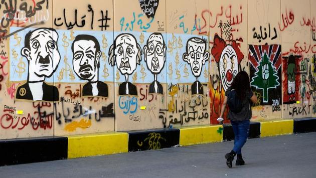 A woman walks past graffiti sprayed on a wall. Nearby, Rida Mawla left a meeting and decided to take a walk in the city centre, something he said he never previously did. “I’m starting to feel like downtown is a bit more like me,” the business consultant said. “In theory it’s the place where everyone should meet, but the ruling class has taken possession of it,” he said. He pointed out his favourite graffiti, a big black tag scrawled on a wall: “Beirut has spoken”. (JOSEPH EID / AFP)