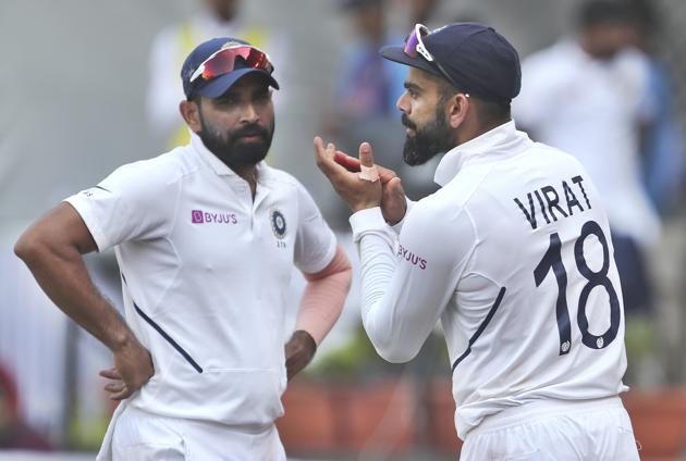 India's Mohammed Shami, left, watches captain Virat Kohli applaud teammates. (AP)