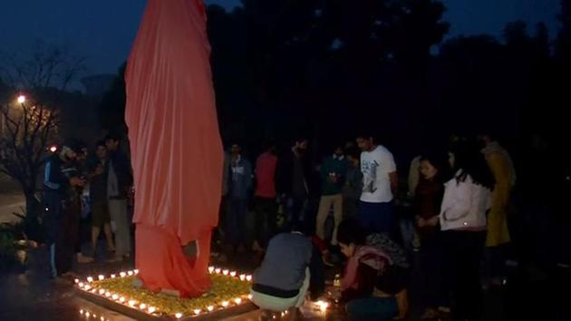 Students decorate the statue of Swami Vivekananda which was defaced, with flowers and lamps at JNU campus in New Delhi on Thursday. (ANI Photo) Students decorate the statue of Swami Vivekananda which was defaced, with flowers and lamps at JNU campus in New Delhi on Thursday. (ANI Photo)